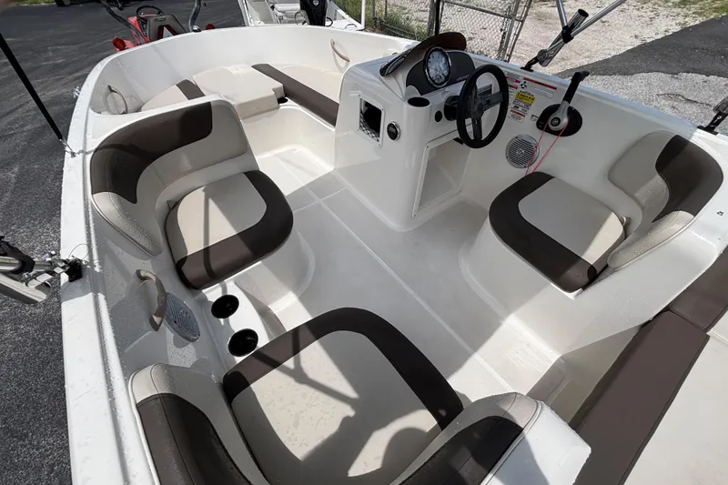 Slide: The Image of 2018 Bayliner Element E16 boat interior with seating and steering console. - 10