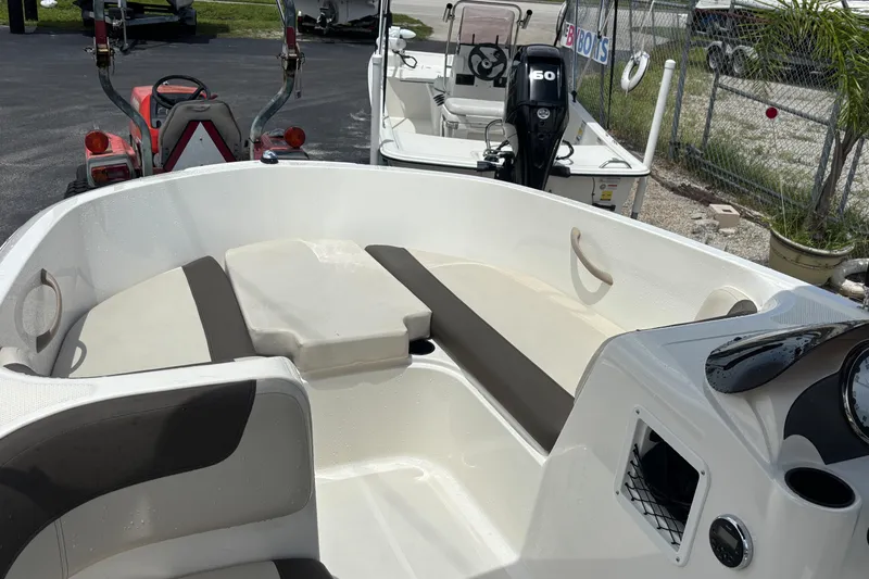 Slide: The Image of 2018 Bayliner Element E16 boat interior with seating and steering console. - 12