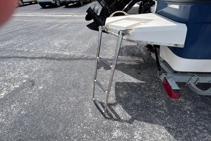 Slide: The Image of 2018 Bayliner Element E16 boat with extended swim ladder on asphalt. - 15