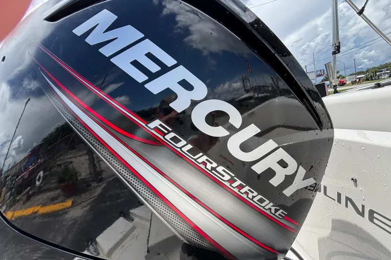 Slide: The Image of Mercury FourStroke engine on 2018 Bayliner Element E16 boat, reflecting sky and surroundings. - 16
