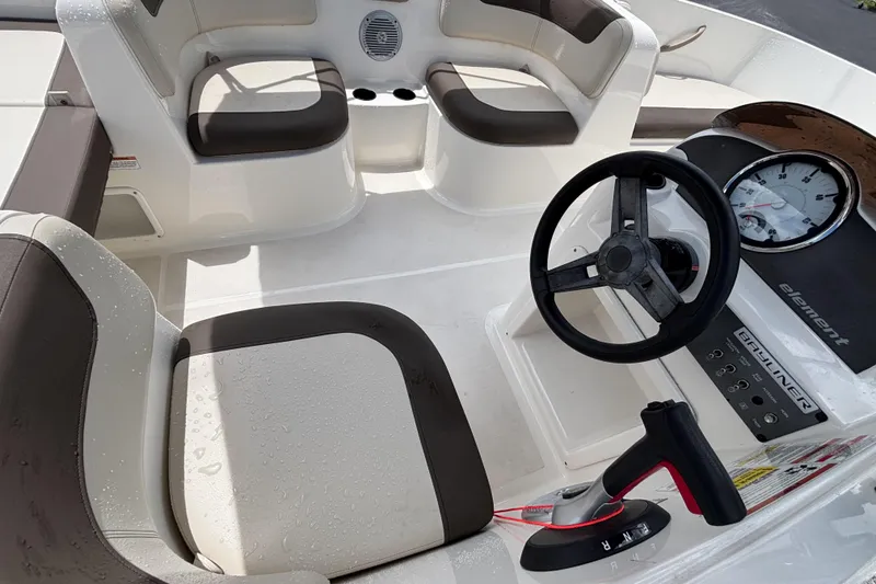 Slide: The Image of 2018 Bayliner Element E16 boat interior with steering wheel and seating area. - 20