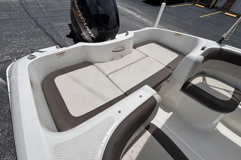 Slide: The Image of 2018 Bayliner Element E16 boat interior with cushioned seating and Mercury outboard motor. - 33
