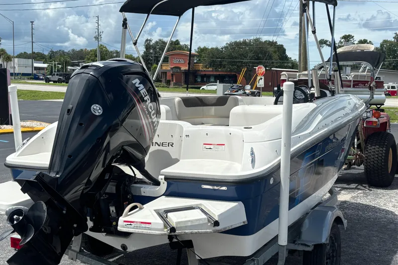 Slide: The Image of 2018 Bayliner Element E16 boat with Mercury outboard motor on a trailer. - 5