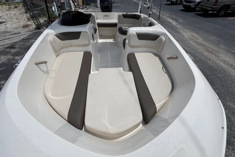 Slide: The Image of 2018 Bayliner Element E16 boat interior with beige and brown seating. - 8