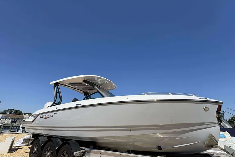 The Image of 2026 Monterey 27 Elite boat on trailer under clear blue sky. - 1
