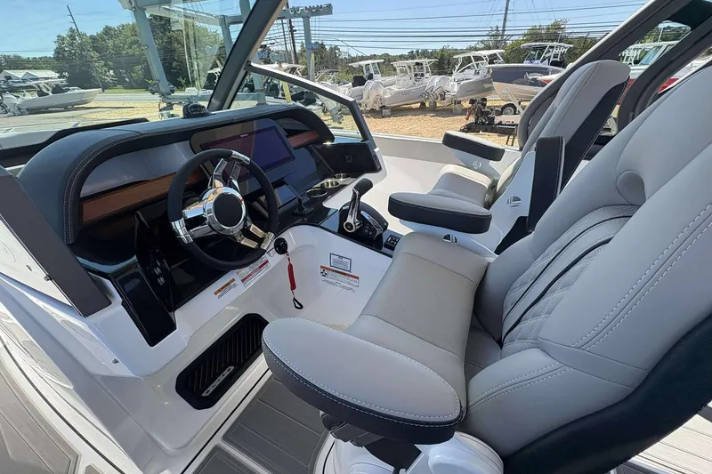 Slide: The Image of Interior of 2026 Monterey 27 Elite boat with modern dashboard and comfortable seating. - 10