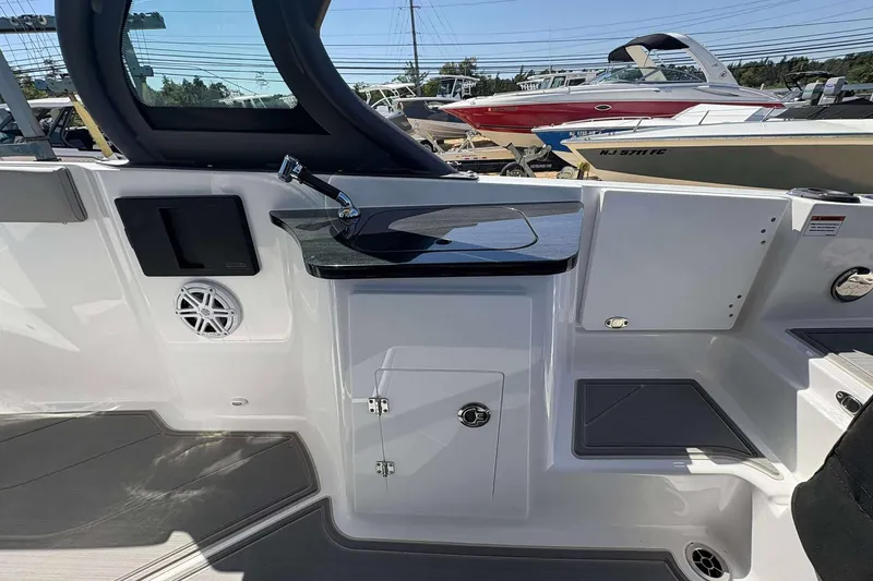 Slide: The Image of Interior view of a 2026 Monterey 27 Elite boat, featuring a sleek sink and speaker. - 18