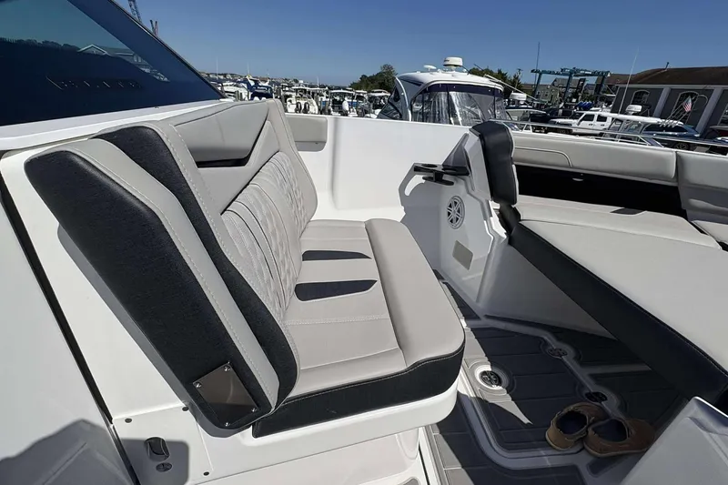 Slide: The Image of Luxurious seating on 2026 Monterey 27 Elite boat, docked at marina under clear skies. - 19