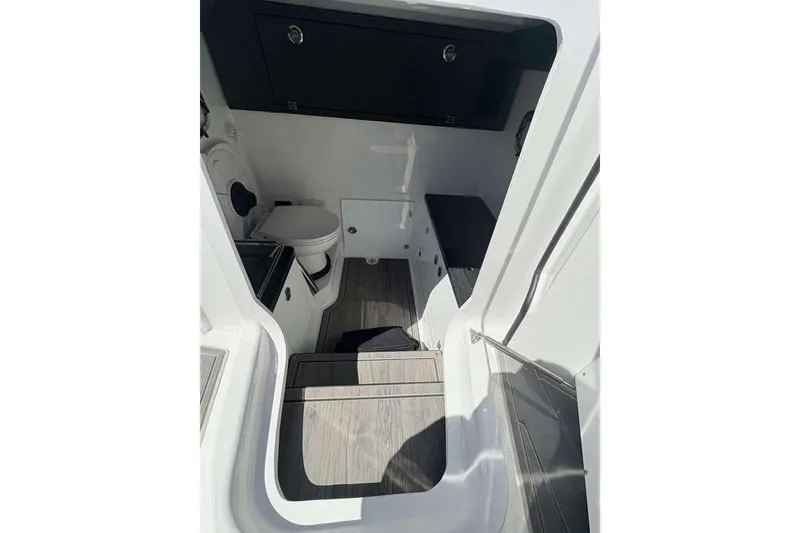 Slide: The Image of Interior of 2026 Monterey 27 Elite boat featuring a compact bathroom with modern amenities. - 24