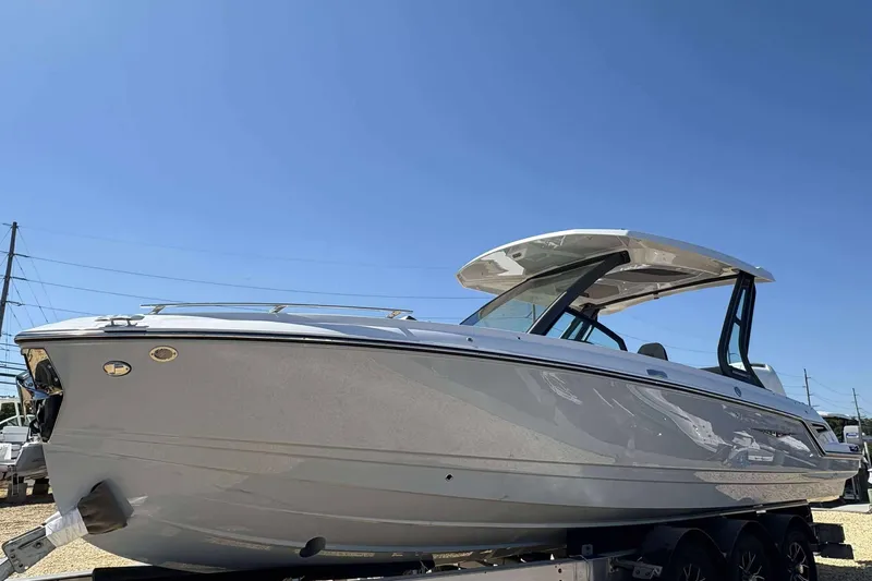 Slide: The Image of 2026 Monterey 27 Elite boat with sleek design on a trailer under clear blue sky. - 3
