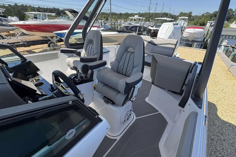 Slide: The Image of 2026 Monterey 27 Elite boat interior with modern seating and steering wheel. - 8