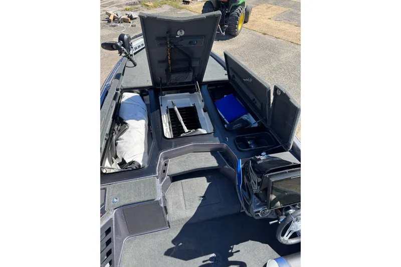 Slide: The Image of 2021 Skeeter FXR21 Apex boat interior with open storage compartments and equipment. - 16