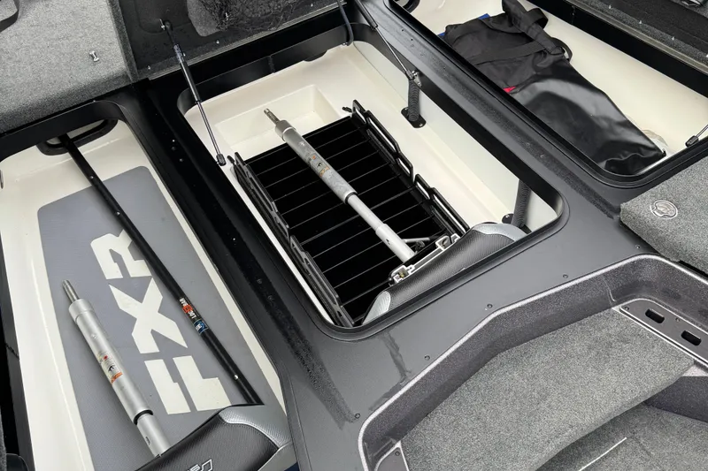 Slide: The Image of 2021 Skeeter FXR21 Apex boat storage compartments with rods and gear. - 17
