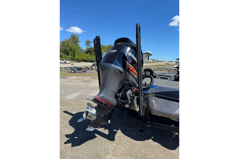 Slide: The Image of 2021 Skeeter FXR21 Apex with Yamaha outboard motor in a sunny outdoor setting. - 20