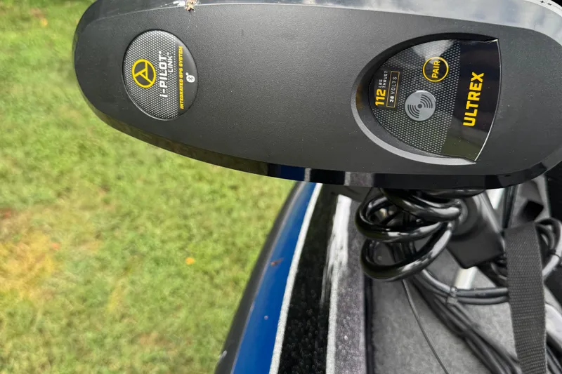 Slide: The Image of 2021 Skeeter FXR21 Apex boat on trailer, parked on grass, surrounded by trees. - 8