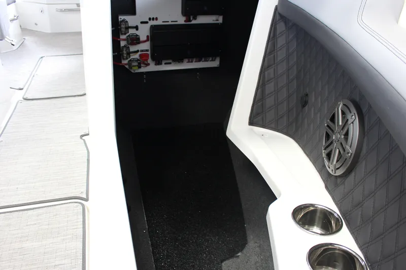 Slide: The Image of Interior of 2025 Cobalt R4 boat featuring speaker and cup holders. - 13