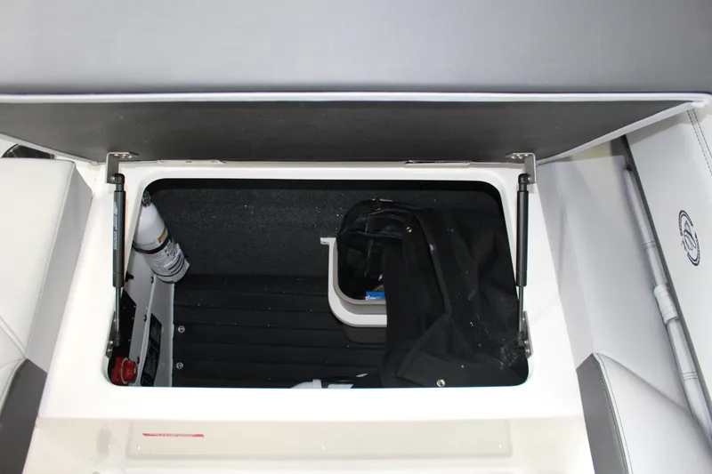 Slide: The Image of Storage compartment in 2025 Cobalt R4 boat, featuring organized interior and safety equipment. - 16