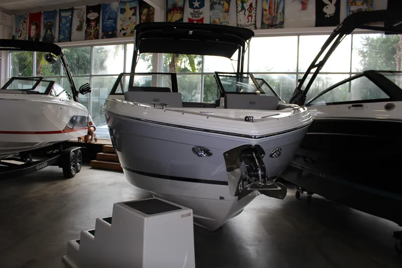 Slide: The Image of 2025 Cobalt R4 boat displayed in a showroom, surrounded by other boats. - 19