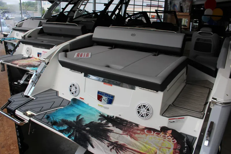 Slide: The Image of 2025 Cobalt R4 boat interior with gray seating and tropical-themed towel. - 2