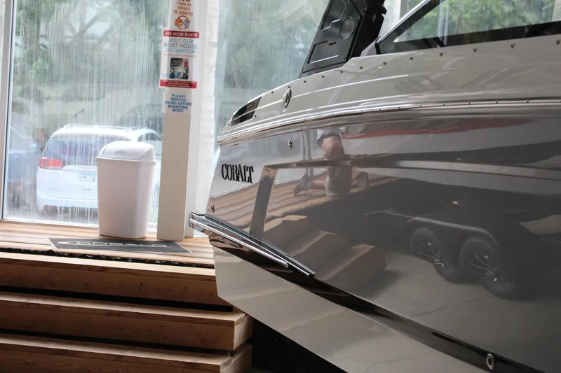 Slide: The Image of 2025 Cobalt R4 boat displayed indoors near a window and trash bin. - 20