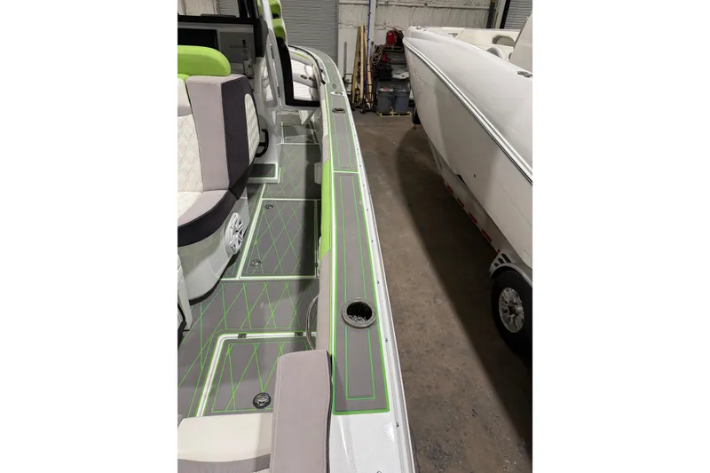 Slide: The Image of 2017 Statement 350 Open boat interior with green accents and seating. - 18