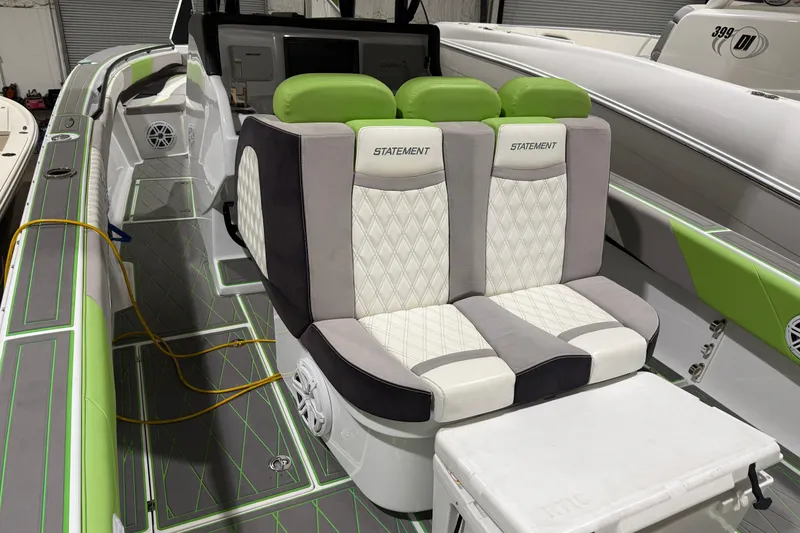 Slide: The Image of Luxury seating on 2017 Statement 350 Open boat with green accents and diamond stitching. - 24