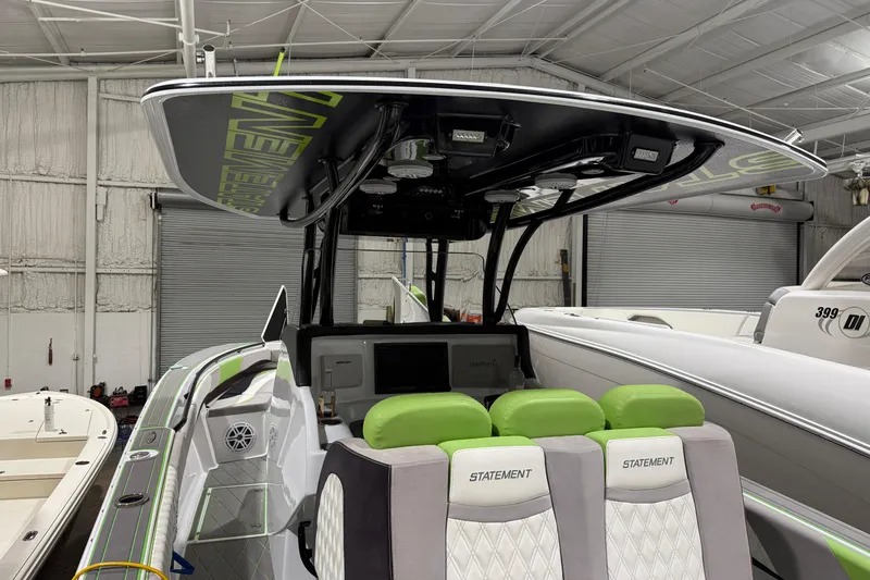 Slide: The Image of 2017 Statement 350 Open boat with green accents in a warehouse setting. - 25