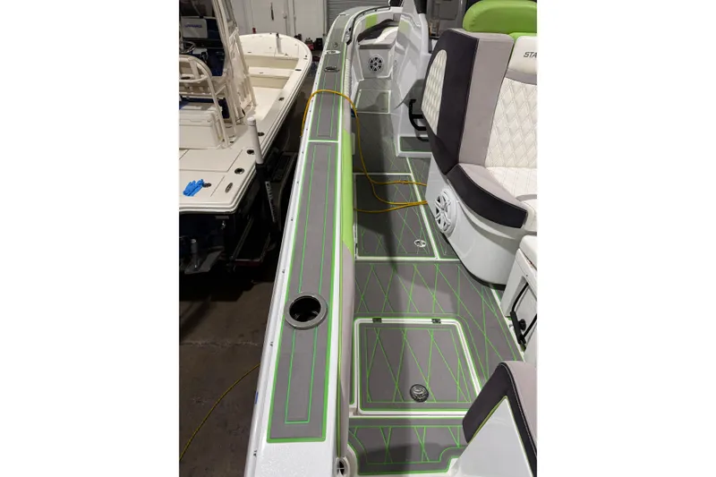Slide: The Image of 2017 Statement 350 Open boat interior with gray and green flooring, cushioned seating. - 35