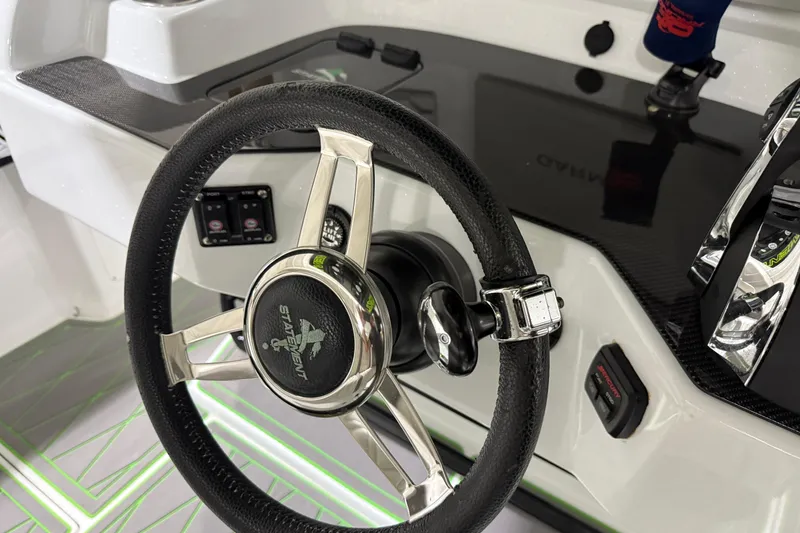 Slide: The Image of Steering wheel and controls of a 2017 Statement 350 Open boat cockpit. - 36