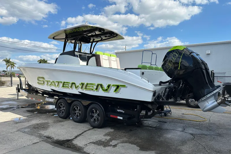 Slide: The Image of 2017 Statement 350 Open boat on trailer, featuring powerful outboard engines. - 4