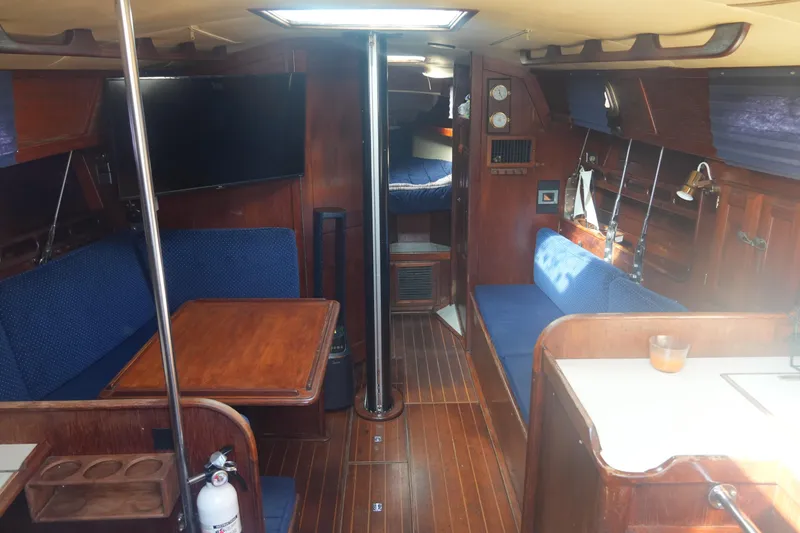 Slide: The Image of Interior of 1984 Ericson 38 sailboat with wooden furnishings and blue upholstery. - 11