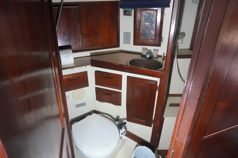 Slide: The Image of 1984 Ericson 38 sailboat bathroom with wooden cabinets and compact sink. - 13