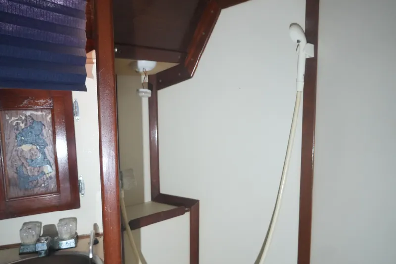 Slide: The Image of Interior of 1984 Ericson 38 sailboat with wooden cabinetry and shower fixture. - 14