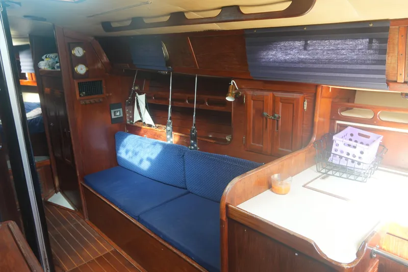 Slide: The Image of Interior of 1984 Ericson 38 sailboat with wooden furnishings and blue upholstery. - 17