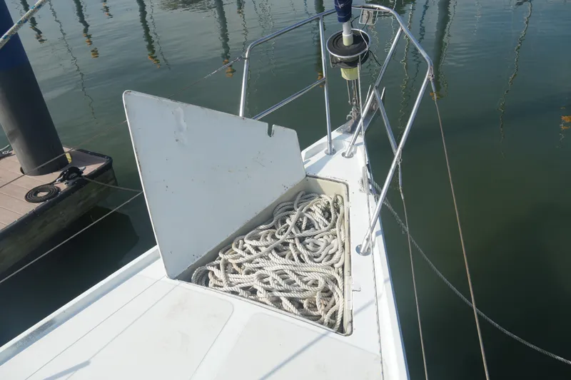 Slide: The Image of 1984 Ericson 38 sailboat with open anchor locker, coiled ropes visible. - 5