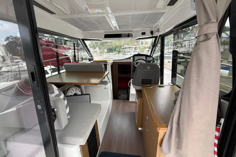 Slide: The Image of Interior of 2020 Jeanneau NC 895 boat, featuring seating and helm station. - 15