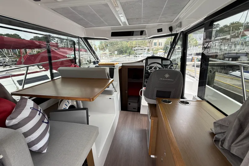 Slide: The Image of Interior of 2020 Jeanneau NC 895 boat with helm, seating, and dining area. - 16