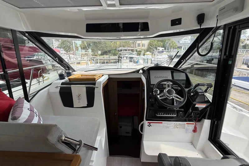 Slide: The Image of Interior view of 2020 Jeanneau NC 895 boat with steering wheel and navigation equipment. - 18