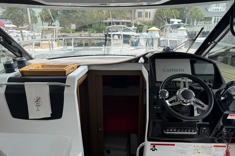 Slide: The Image of Interior view of 2020 Jeanneau NC 895 boat cockpit with Garmin navigation system. - 19