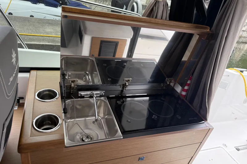 Slide: The Image of Compact kitchen area on 2020 Jeanneau NC 895 boat with sink and stove. - 28