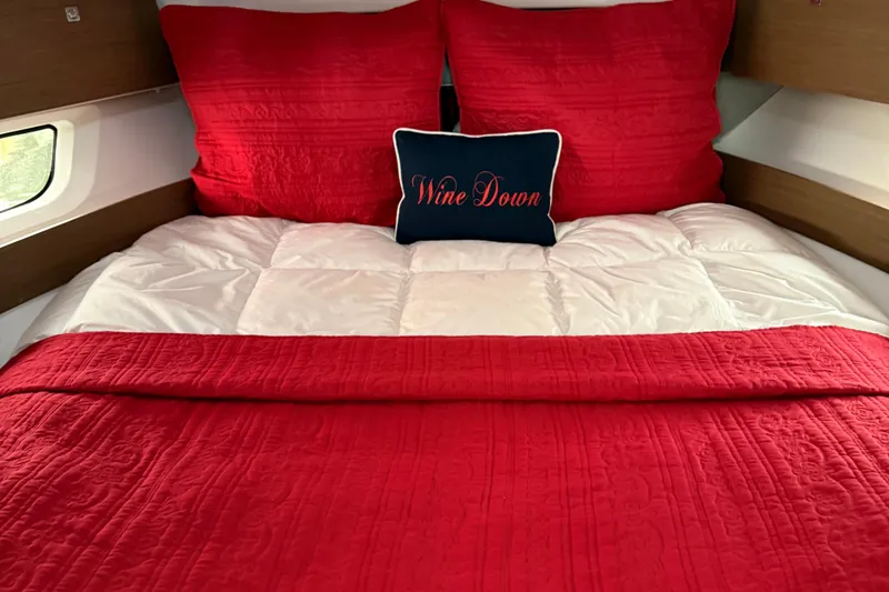 Slide: The Image of Cozy bed with red bedding in 2020 Jeanneau NC 895 boat cabin. - 31