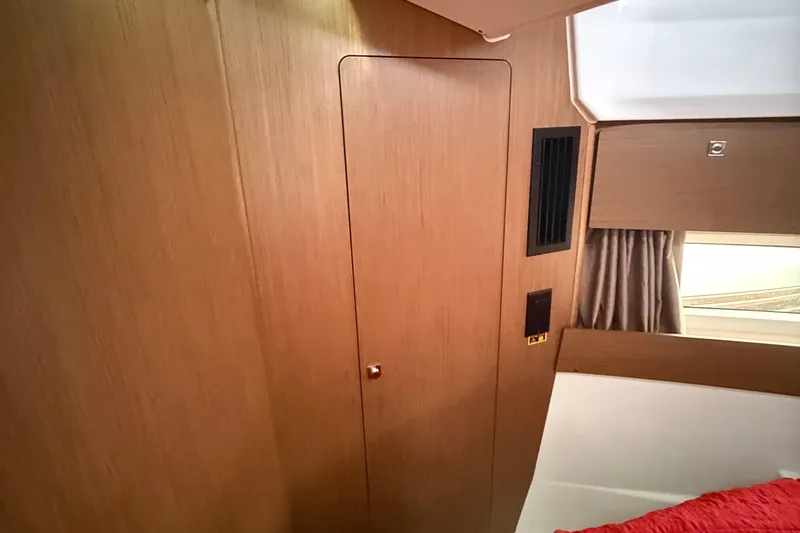 Slide: The Image of Interior of 2020 Jeanneau NC 895 boat with wooden paneling and window curtain. - 35