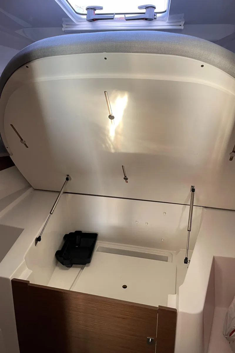 Slide: The Image of 2020 Jeanneau NC 895 interior storage compartment with open lid. - 36