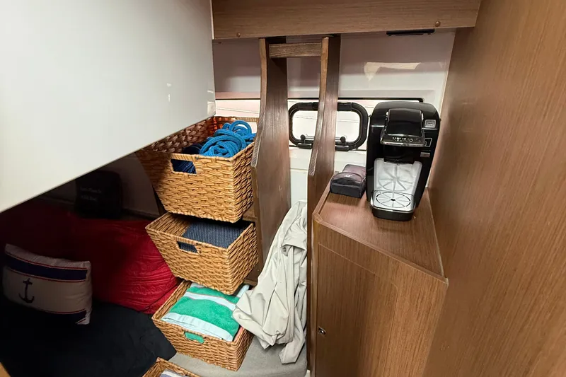 Slide: The Image of Interior of 2020 Jeanneau NC 895 with storage baskets and coffee maker. - 40