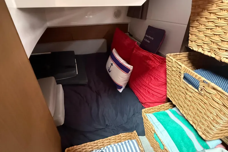Slide: The Image of Cozy cabin interior of 2020 Jeanneau NC 895 with cushions and woven baskets. - 41