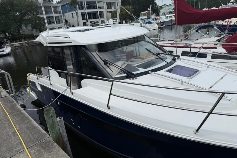 Slide: The Image of 2020 Jeanneau NC 895 boat docked at marina, featuring sleek design and modern amenities. - 6