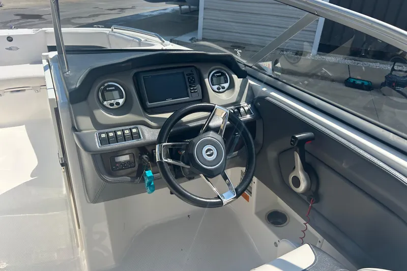 Slide: The Image of 2016 Chaparral 230 Suncoast boat interior with steering wheel and seating. - 12