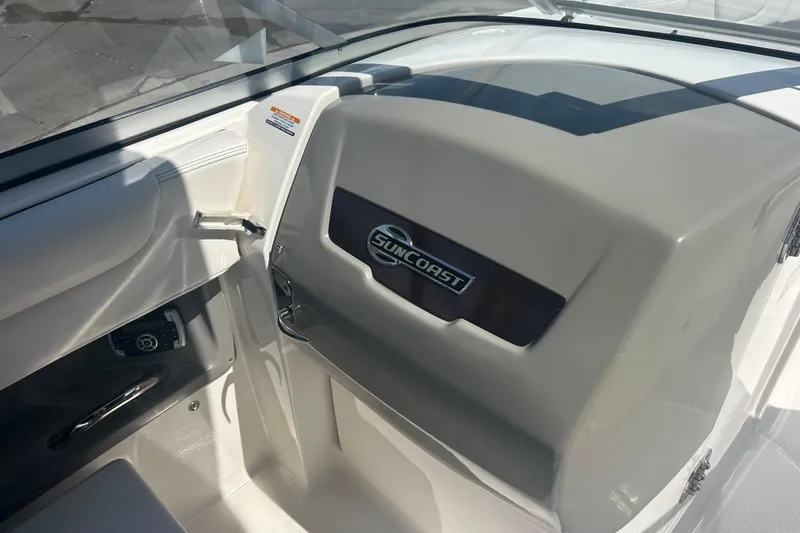 Slide: The Image of 2016 Chaparral 230 Suncoast boat dashboard with steering wheel and control panel. - 13