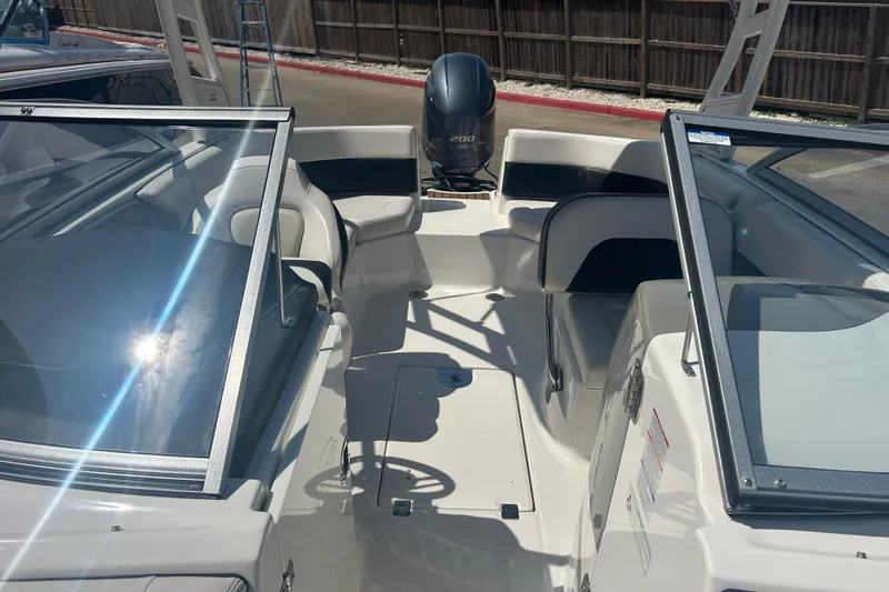 Slide: The Image of 2016 Chaparral 230 Suncoast boat interior with white seating and spacious layout. - 16