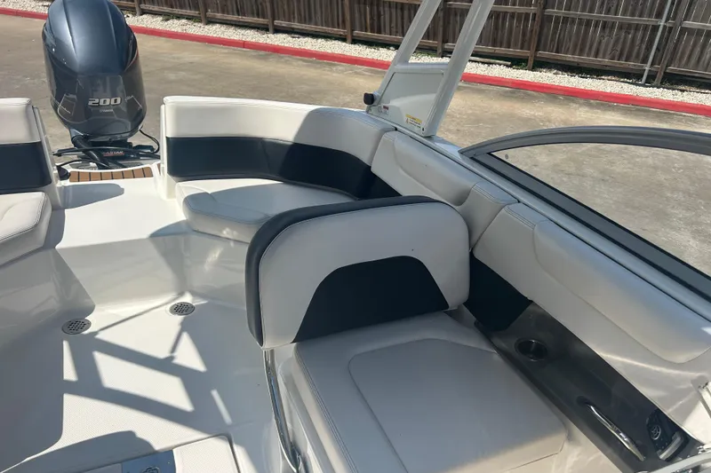 Slide: The Image of 2016 Chaparral 230 Suncoast boat interior with seating and Yamaha 200 engine. - 18